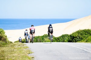 At the farthest point of the 2 loop bike circuit is the Maitland river mouth, and the Maitland ‘sand mountain’. At this point riders turn left up a steep hill and hit the prevailing Easterly wind. Beyond this turnaround are hundreds of miles of stunning beaches along South Africa’s Garden Route.